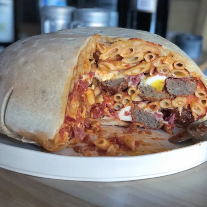 The Tucci Timpano: Jay Rayner and Stanley Tucci reveal the baked timpano. Photograph: Sophia Spring/The Observer